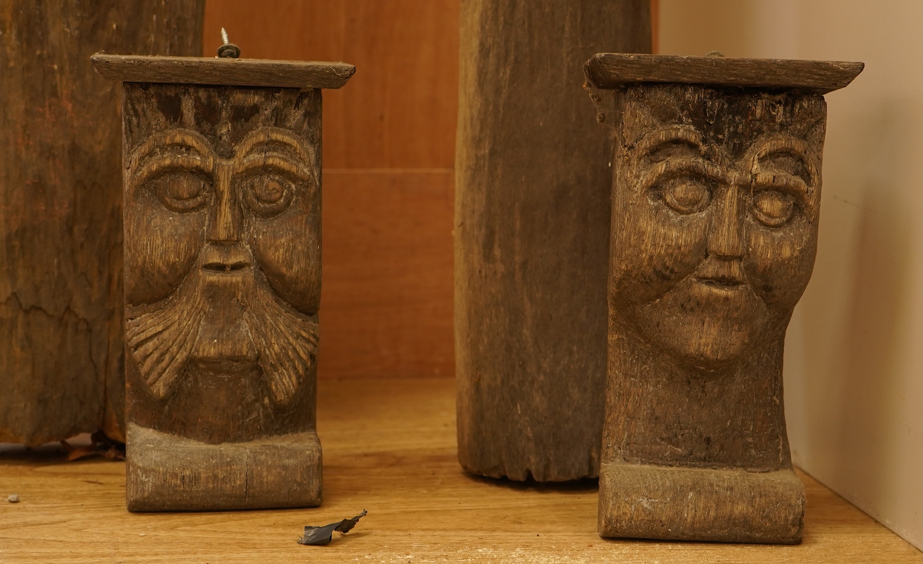 Two African carved wood ancestor figures, tallest 171cm, with two European carved mask capitals